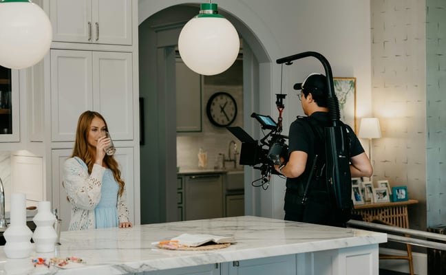 Film crew shooting inside a luxury property kitchen