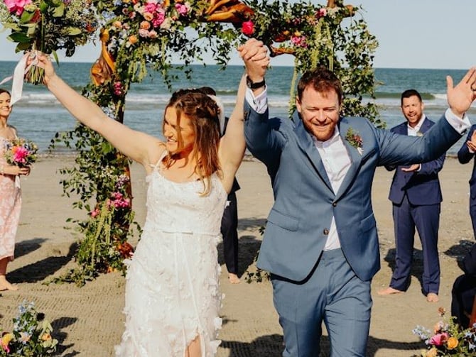 Newlyweds celebrating at The Three Authors as guests cheer