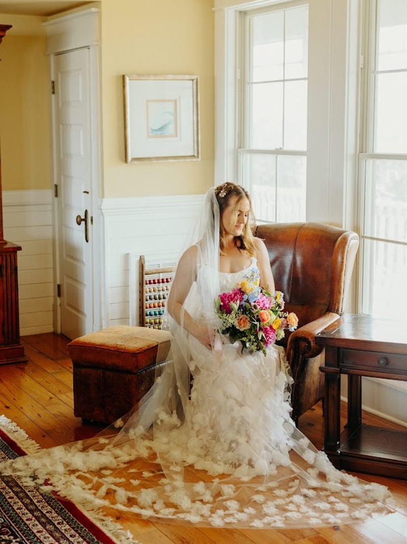 Bride getting ready in the library at The Three Authors