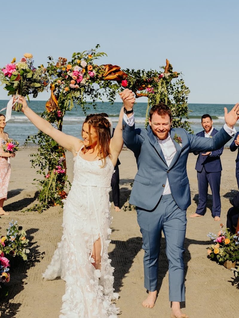 Newlyweds celebrating as guests cheer