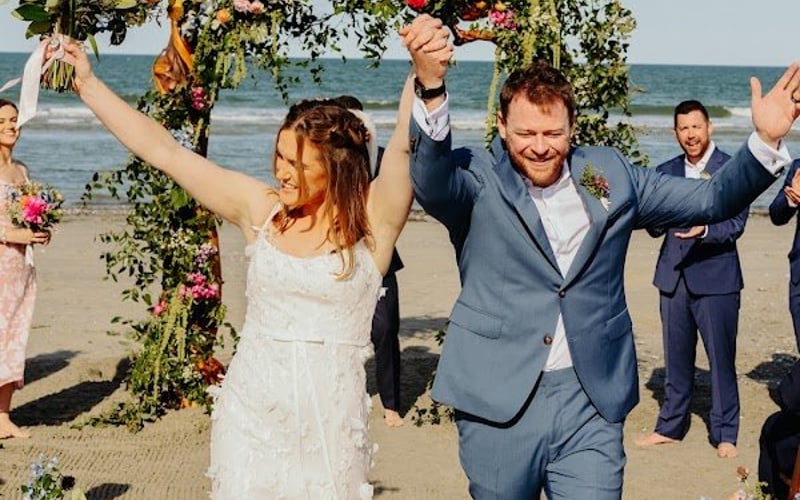 Newlyweds celebrating as guests cheer